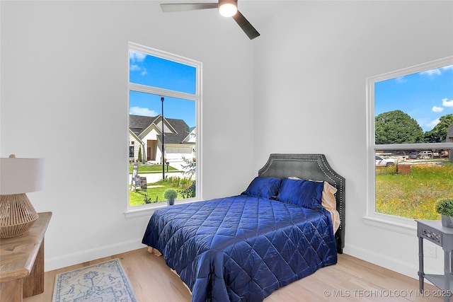 12005 S Vandalia Ave, Tulsa, OK 74137 - bedroom with wood finished floors, multiple windows, and ceiling fan