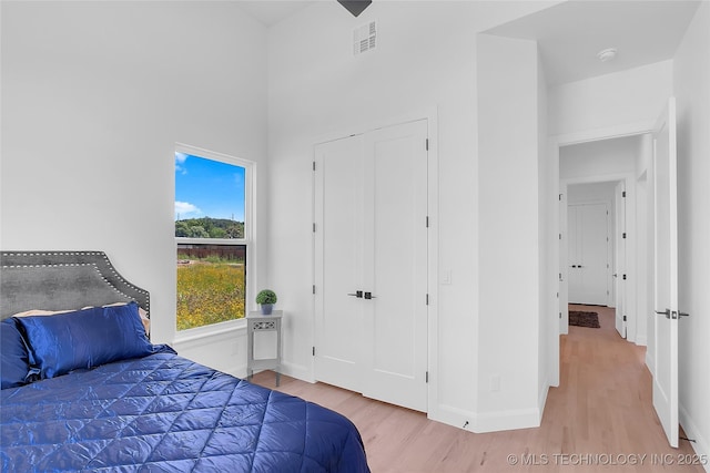 12005 S Vandalia Ave, Tulsa, OK 74137 - bedroom featuring wood finished floors and a towering ceiling