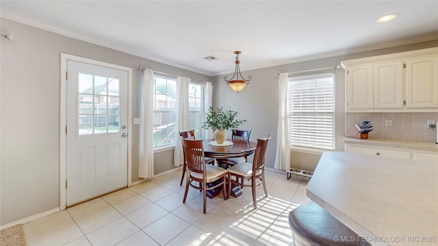 1010 W 120th St, Jenks, OK 74037 - dining area featuring crown molding and light tile patterned floors