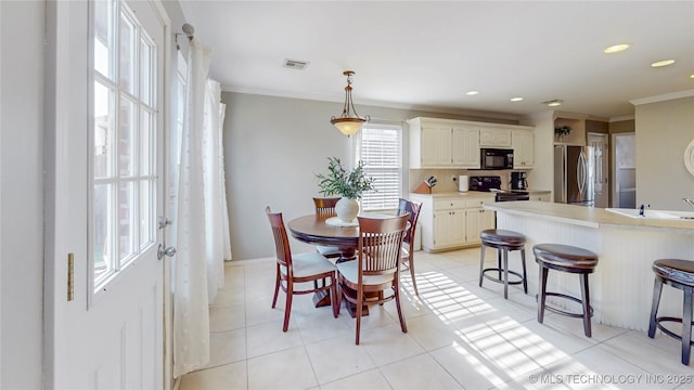 1010 W 120th St, Jenks, OK 74037 - dining room with ornamental molding, light tile patterned floors, and recessed lighting