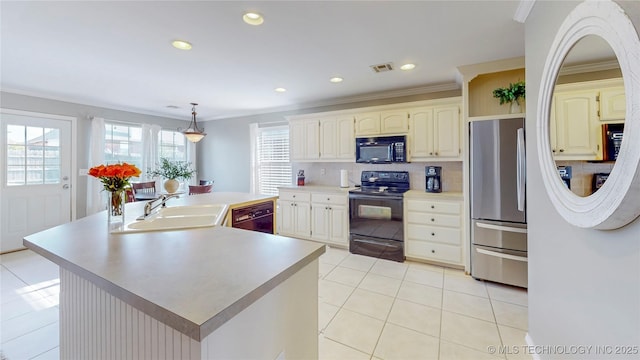 1010 W 120th St, Jenks, OK 74037 - kitchen featuring black appliances, light countertops, a kitchen island with sink, decorative backsplash, and light tile patterned floors