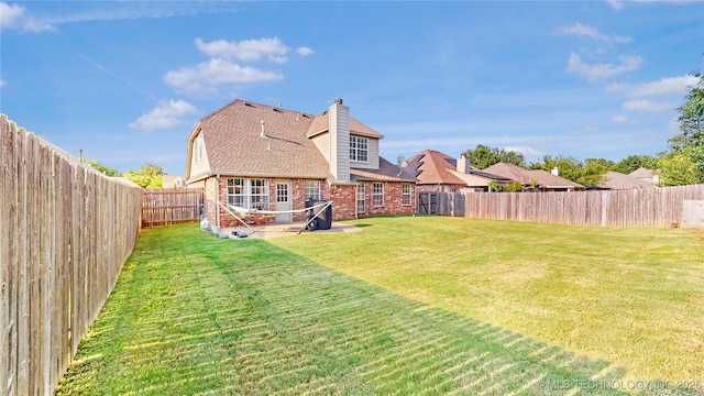 1010 W 120th St, Jenks, OK 74037 - rear view of property with brick siding, a fenced backyard, a patio area, roof with shingles, and a chimney