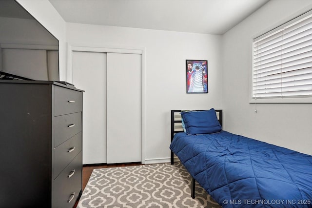 7547 E 27th St, Tulsa, OK 74129 - bedroom featuring a closet and wood finished floors