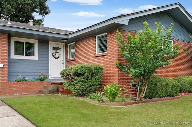 7547 E 27th St, Tulsa, OK 74129 - view of front of home featuring brick siding and a front lawn