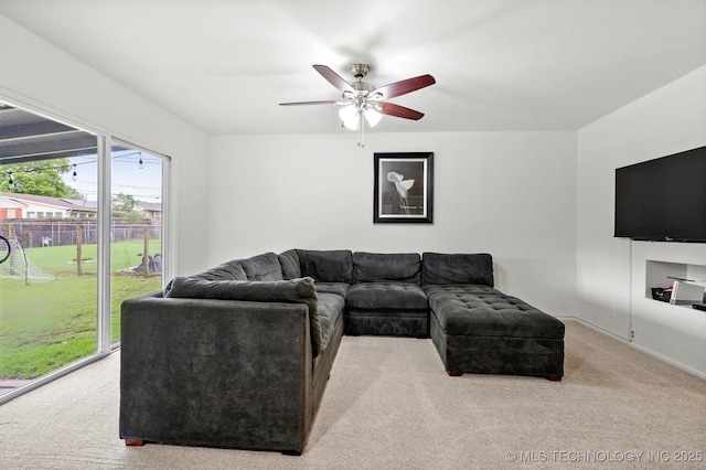 7547 E 27th St, Tulsa, OK 74129 - carpeted living area featuring a ceiling fan and baseboards