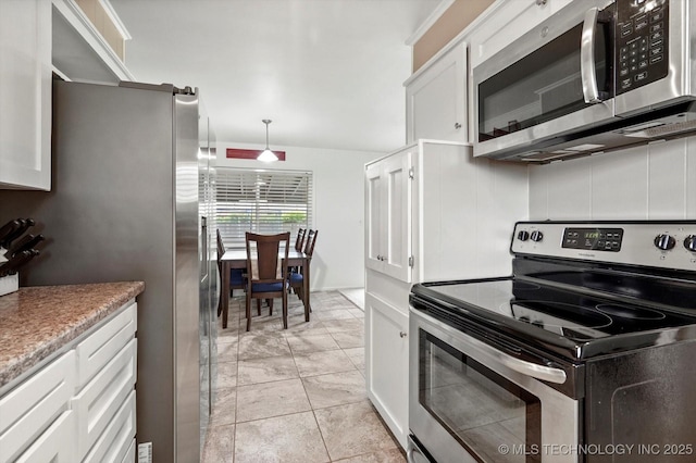 7547 E 27th St, Tulsa, OK 74129 - kitchen with appliances with stainless steel finishes, white cabinetry, hanging light fixtures, and light countertops
