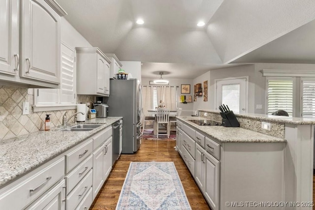 1516 W Trenton St, Broken Arrow, OK 74012 - kitchen featuring a center island, lofted ceiling, white cabinetry, dark wood-type flooring, and decorative backsplash