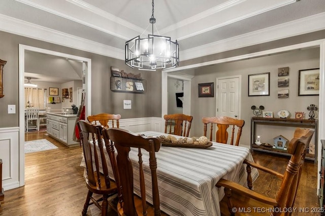 1516 W Trenton St, Broken Arrow, OK 74012 - dining space featuring a chandelier, wood finished floors, wainscoting, ornamental molding, and a decorative wall