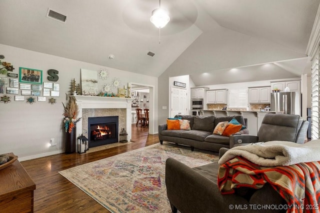1516 W Trenton St, Broken Arrow, OK 74012 - living room with ceiling fan, a fireplace with flush hearth, dark wood finished floors, and high vaulted ceiling