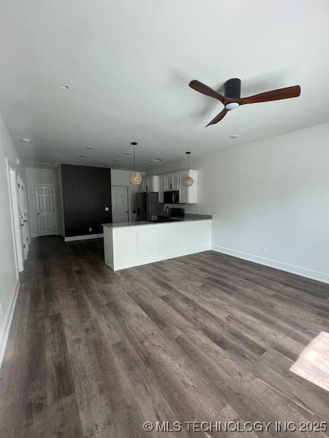 516 S Creek Ave S, Haskell, OK 74436 - unfurnished living room with dark wood finished floors and ceiling fan