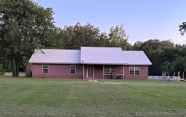 3176 E 2030th Rd, Sawyer, OK 74756 - single story home featuring a metal roof, brick siding, and a front lawn