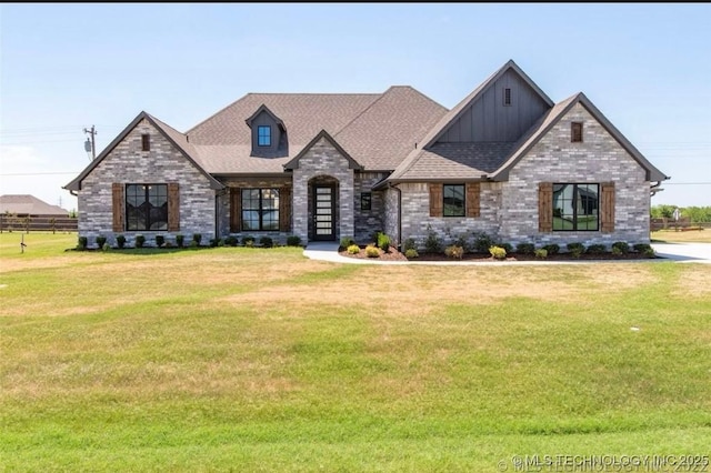 9022 N 65th Pl E, Owasso, OK 74055 - view of front of house featuring board and batten siding, a front yard, and brick siding