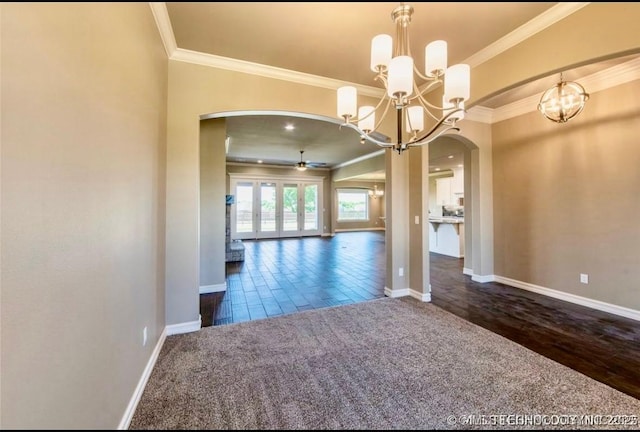 9022 N 65th Pl E, Owasso, OK 74055 - unfurnished dining area with arched walkways, a chandelier, ceiling fan, ornamental molding, and dark wood-type flooring