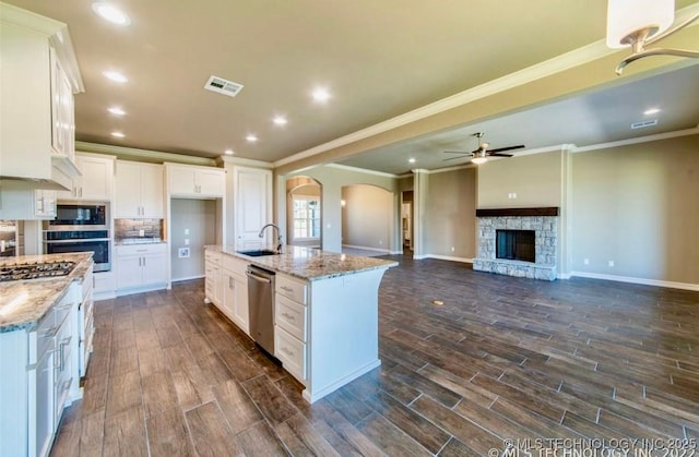 9022 N 65th Pl E, Owasso, OK 74055 - kitchen featuring stainless steel appliances, dark wood-style flooring, crown molding, a ceiling fan, and white cabinetry