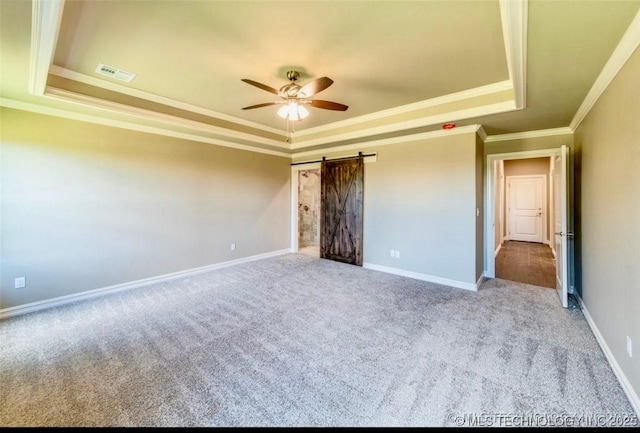 9022 N 65th Pl E, Owasso, OK 74055 - unfurnished bedroom featuring a tray ceiling, carpet floors, crown molding, a barn door, and ceiling fan