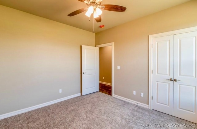 9022 N 65th Pl E, Owasso, OK 74055 - unfurnished bedroom with carpet, a closet, and ceiling fan