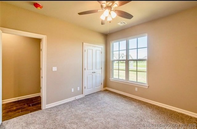 9022 N 65th Pl E, Owasso, OK 74055 - unfurnished bedroom with carpet, a closet, and ceiling fan