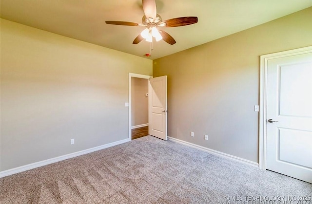 9022 N 65th Pl E, Owasso, OK 74055 - carpeted spare room featuring ceiling fan and baseboards