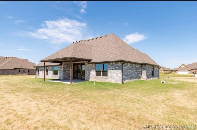 9022 N 65th Pl E, Owasso, OK 74055 - rear view of house with a patio area, a yard, brick siding, and a shingled roof