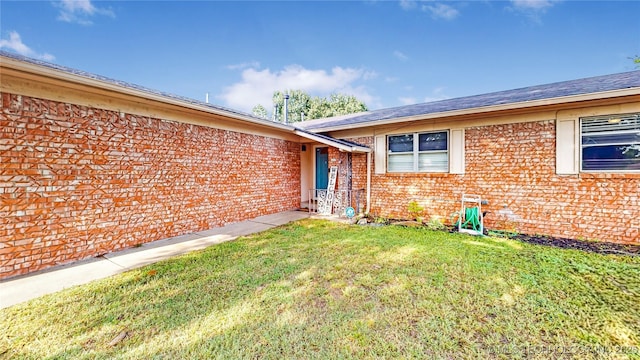 5605 S 95th E Ave, Tulsa, OK 74145 - doorway to property with a yard and brick siding