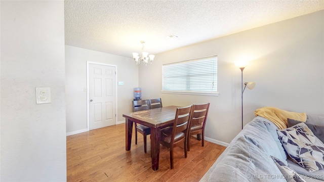 5605 S 95th E Ave, Tulsa, OK 74145 - dining space featuring a chandelier, light wood-style flooring, and a textured ceiling