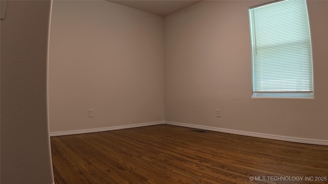 5921 S Sandusky Ave, Tulsa, OK 74135 - unfurnished room with dark wood-style floors and baseboards