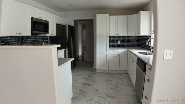 5921 S Sandusky Ave, Tulsa, OK 74135 - kitchen featuring stainless steel appliances, decorative backsplash, light marble finish flooring, and white cabinets