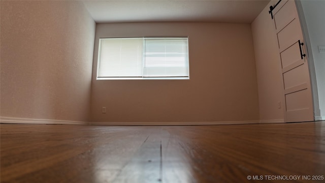 5921 S Sandusky Ave, Tulsa, OK 74135 - spare room featuring wood finished floors and a barn door