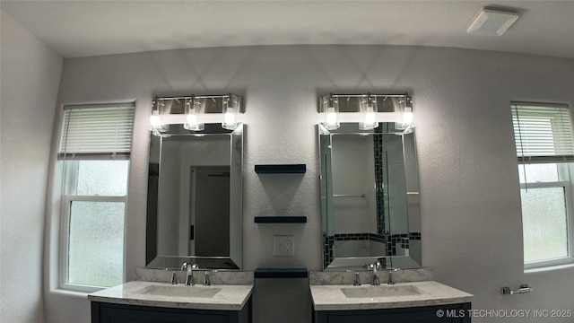 5921 S Sandusky Ave, Tulsa, OK 74135 - full bathroom featuring two vanities and a textured wall