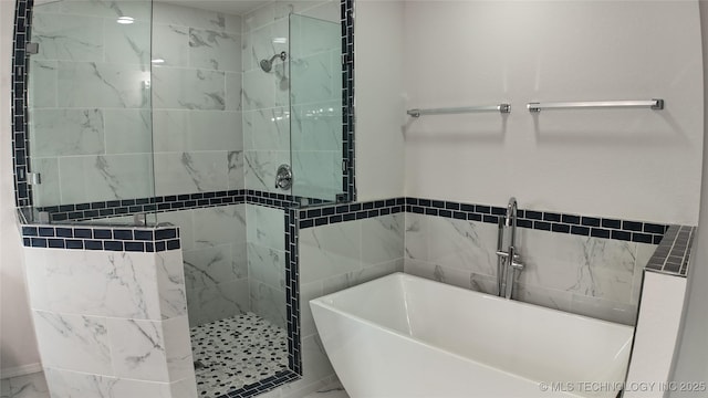 5921 S Sandusky Ave, Tulsa, OK 74135 - full bath featuring a freestanding bath, a tile shower, pet washing area, and marble look tiles