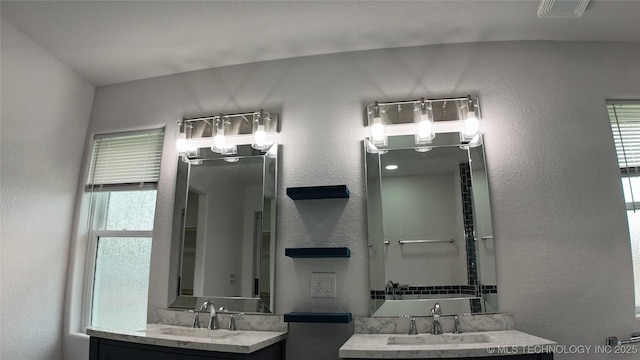 5921 S Sandusky Ave, Tulsa, OK 74135 - full bathroom with two vanities and a textured wall
