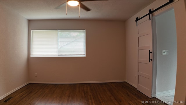 5921 S Sandusky Ave, Tulsa, OK 74135 - spare room with a barn door, dark wood-style flooring, and ceiling fan