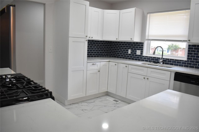 5921 S Sandusky Ave, Tulsa, OK 74135 - kitchen featuring dishwasher, backsplash, white cabinetry, and light marble finish floors