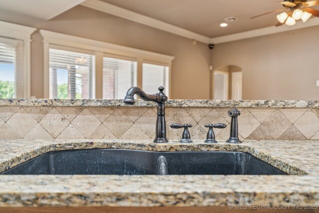 9200 E 92nd Pl, Owasso, OK 74055 - kitchen view of decorative backsplash, ceiling fan, light stone countertops, and recessed lighting