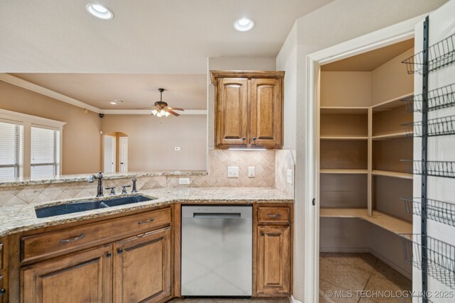 9200 E 92nd Pl, Owasso, OK 74055 - kitchen with dishwasher, light stone counters, brown cabinetry, decorative backsplash, and a ceiling fan