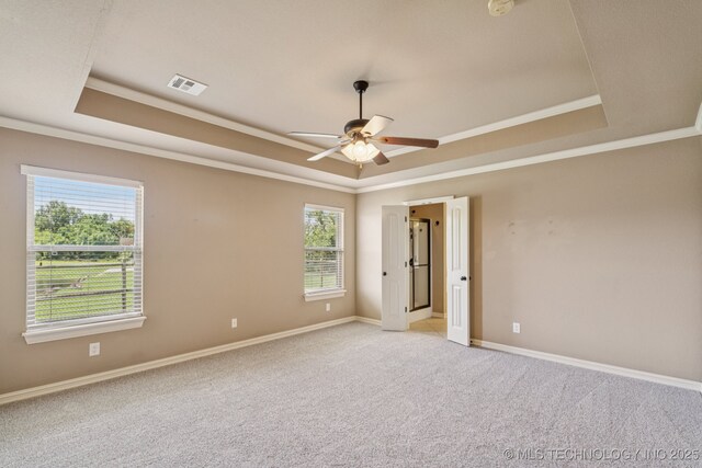 9200 E 92nd Pl, Owasso, OK 74055 - spare room with a tray ceiling, ceiling fan, ornamental molding, and light colored carpet