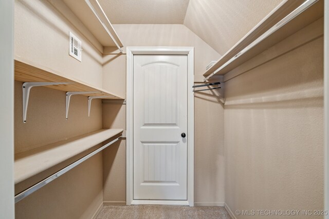 9200 E 92nd Pl, Owasso, OK 74055 - spacious closet with lofted ceiling and carpet
