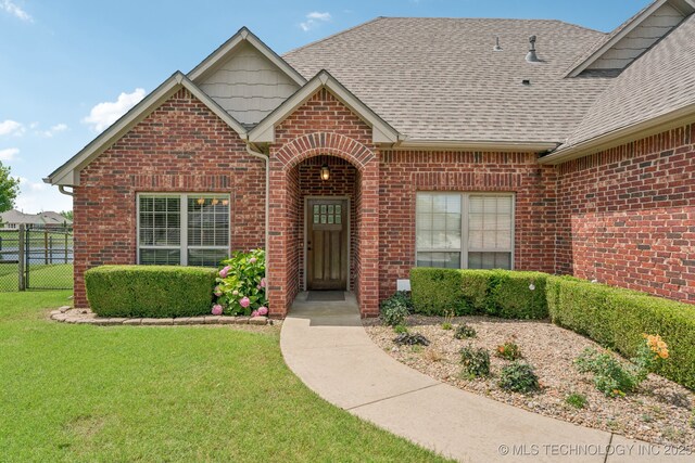 9200 E 92nd Pl, Owasso, OK 74055 - view of front of home with brick siding and roof with shingles
