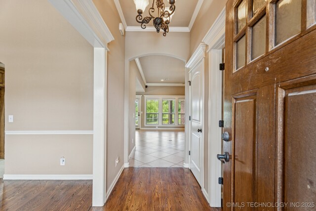 9200 E 92nd Pl, Owasso, OK 74055 - foyer featuring arched walkways, crown molding, wood finished floors, and a chandelier
