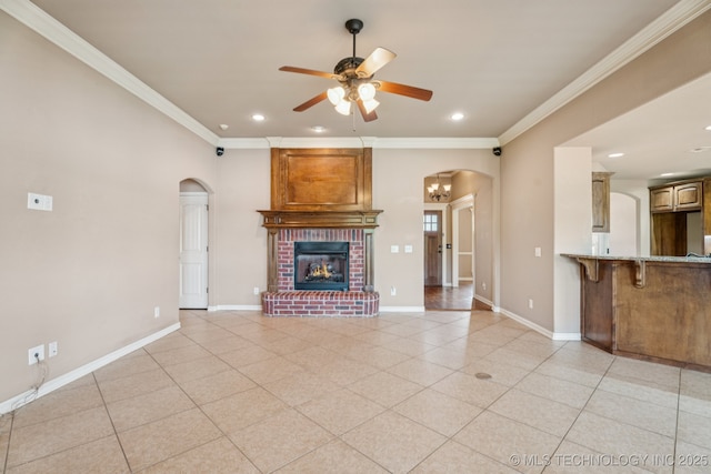 9200 E 92nd Pl, Owasso, OK 74055 - unfurnished living room featuring arched walkways, a ceiling fan, crown molding, light tile patterned flooring, and recessed lighting
