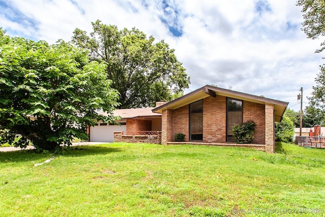 7025 E 58th Pl, Tulsa, OK 74145 - view of front of home featuring an attached garage, a front yard, and brick siding