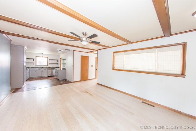 7025 E 58th Pl, Tulsa, OK 74145 - unfurnished living room featuring a ceiling fan, light wood-type flooring, and beam ceiling
