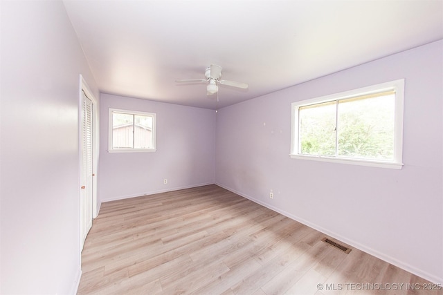 7025 E 58th Pl, Tulsa, OK 74145 - empty room with healthy amount of natural light, light wood-style flooring, and ceiling fan