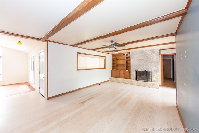 7025 E 58th Pl, Tulsa, OK 74145 - unfurnished living room featuring beamed ceiling, a ceiling fan, light wood finished floors, a fireplace, and built in shelves