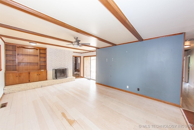 7025 E 58th Pl, Tulsa, OK 74145 - unfurnished living room featuring light wood-type flooring, beamed ceiling, ceiling fan, a fireplace, and built in shelves