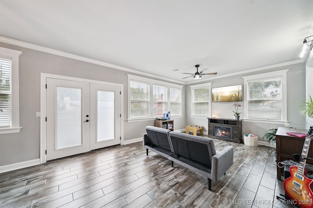 1909 W Nashville St, Broken Arrow, OK 74012 - living area featuring crown molding, wood finished floors, ceiling fan, a glass covered fireplace, and plenty of natural light