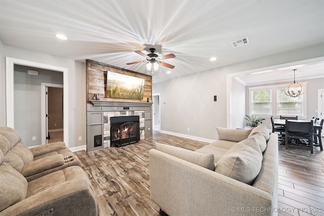 1909 W Nashville St, Broken Arrow, OK 74012 - living area featuring wood finished floors, a chandelier, recessed lighting, a fireplace, and ceiling fan