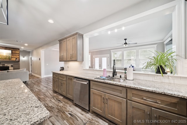 1909 W Nashville St, Broken Arrow, OK 74012 - kitchen featuring stainless steel dishwasher, a ceiling fan, a stone fireplace, recessed lighting, and decorative backsplash