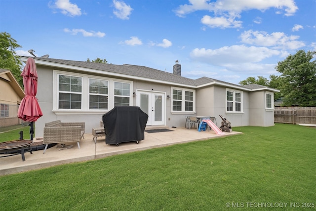 1909 W Nashville St, Broken Arrow, OK 74012 - back of house featuring a patio, a fire pit, stucco siding, and a chimney