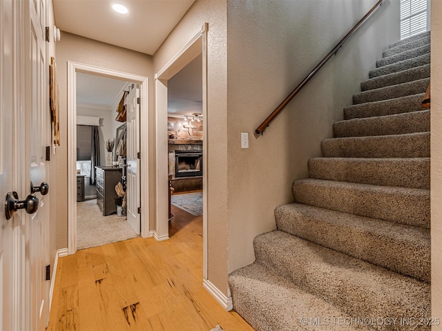 333 Springview Dr, Skiatook, OK 74070 - stairs with wood finished floors, a fireplace, and crown molding